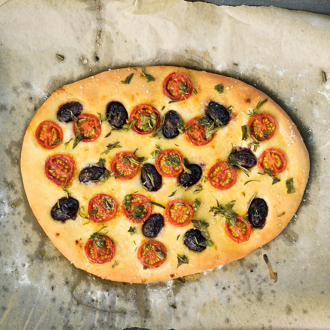 Vegan focaccia with cherry tomatoes and black olives