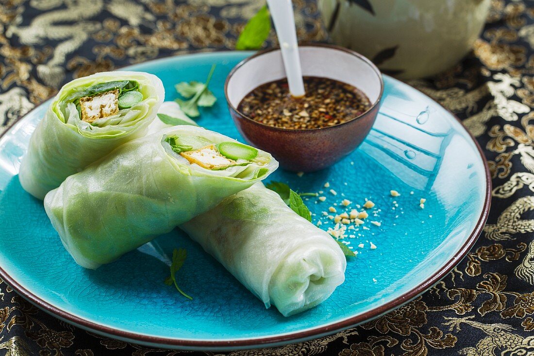 Vegan rice paper rolls with tofu, green asparagus and fresh herbs