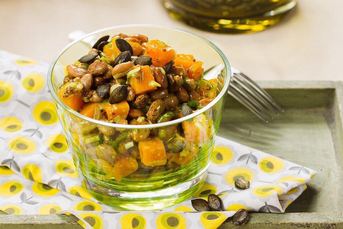 Vegan pumpkin and bean salad with pumpkin seeds
