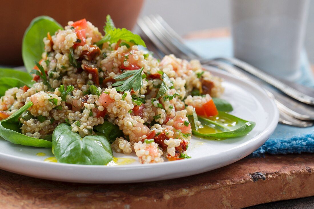 Vegan quinoa salad with tomatoes and fresh herbs