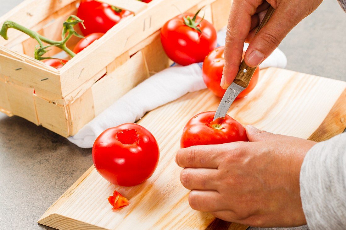 Stems being removed from tomatoes