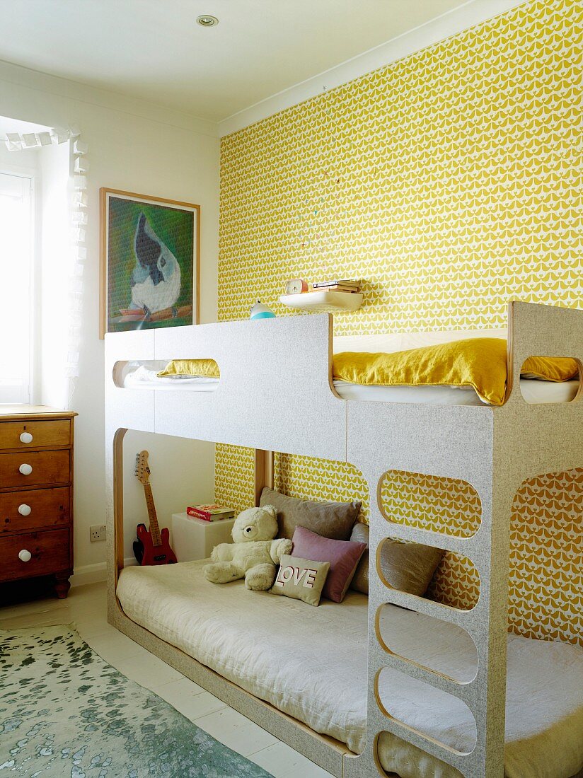 Etagenbett vor tapezierter Wand mit gelbem Retro Muster im Kinderzimmer