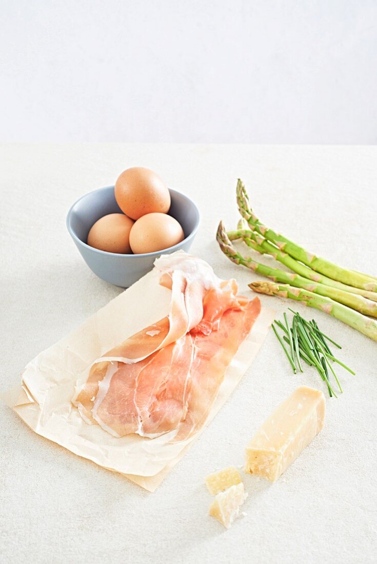 Ingredients for asparagus and Parma ham rolls and Parmesan oeuf cocotte