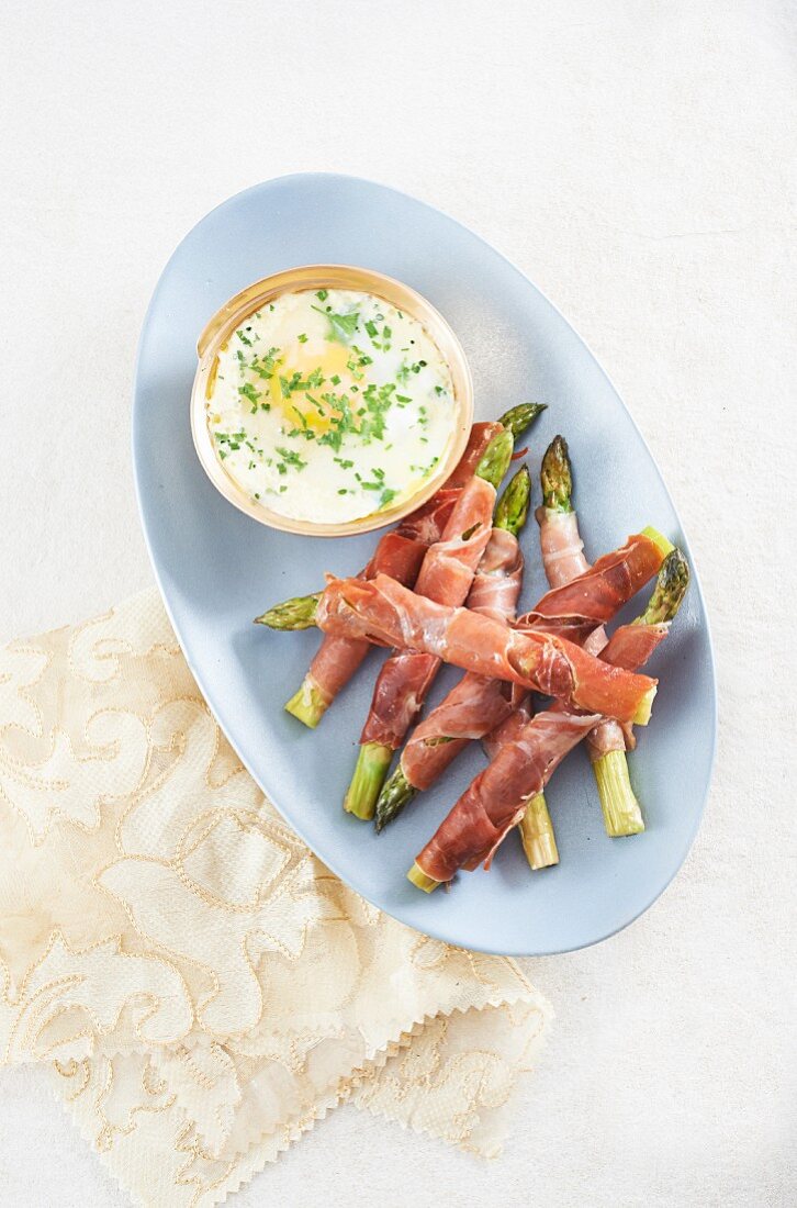Asparagus and Parma ham rolls with Parmesan oeuf cocotte