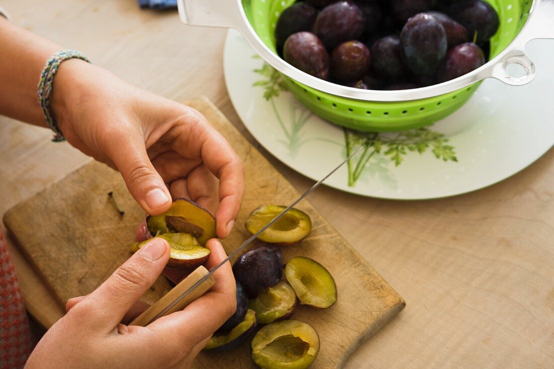 Damsons being pitted