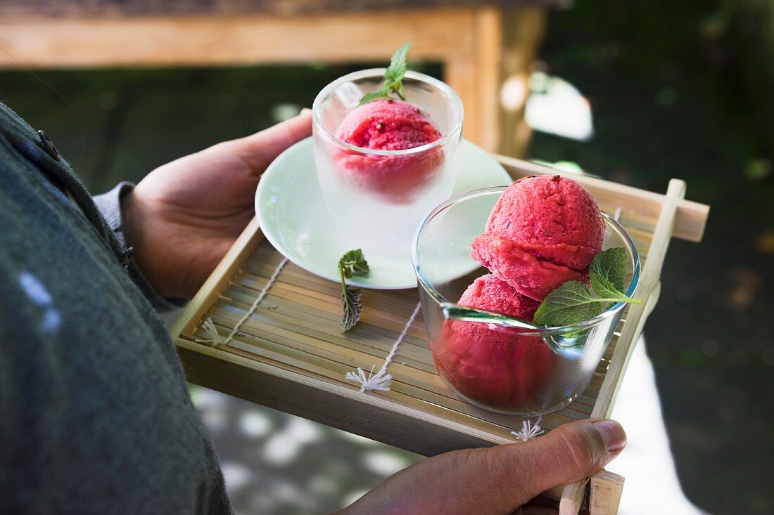 Vegan strawberry sorbet with green pepper being served