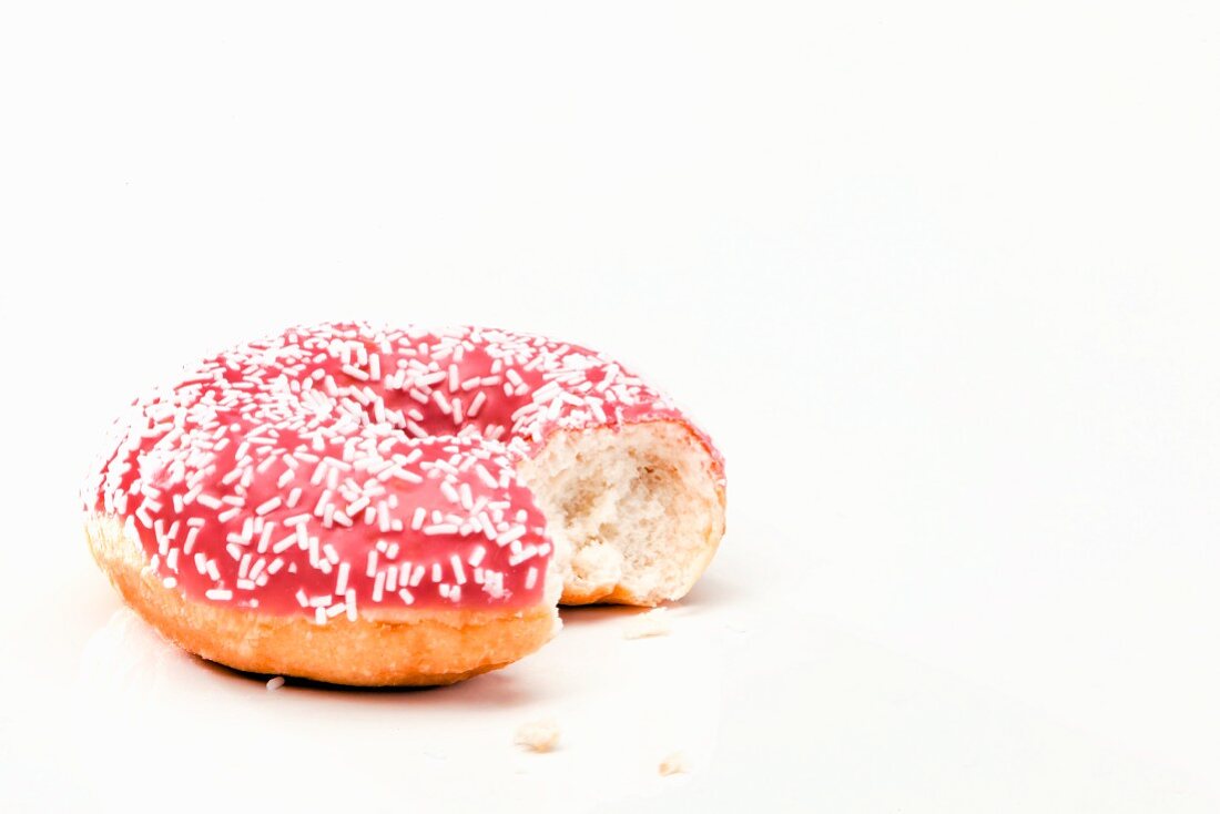 A pink doughnut, bitten