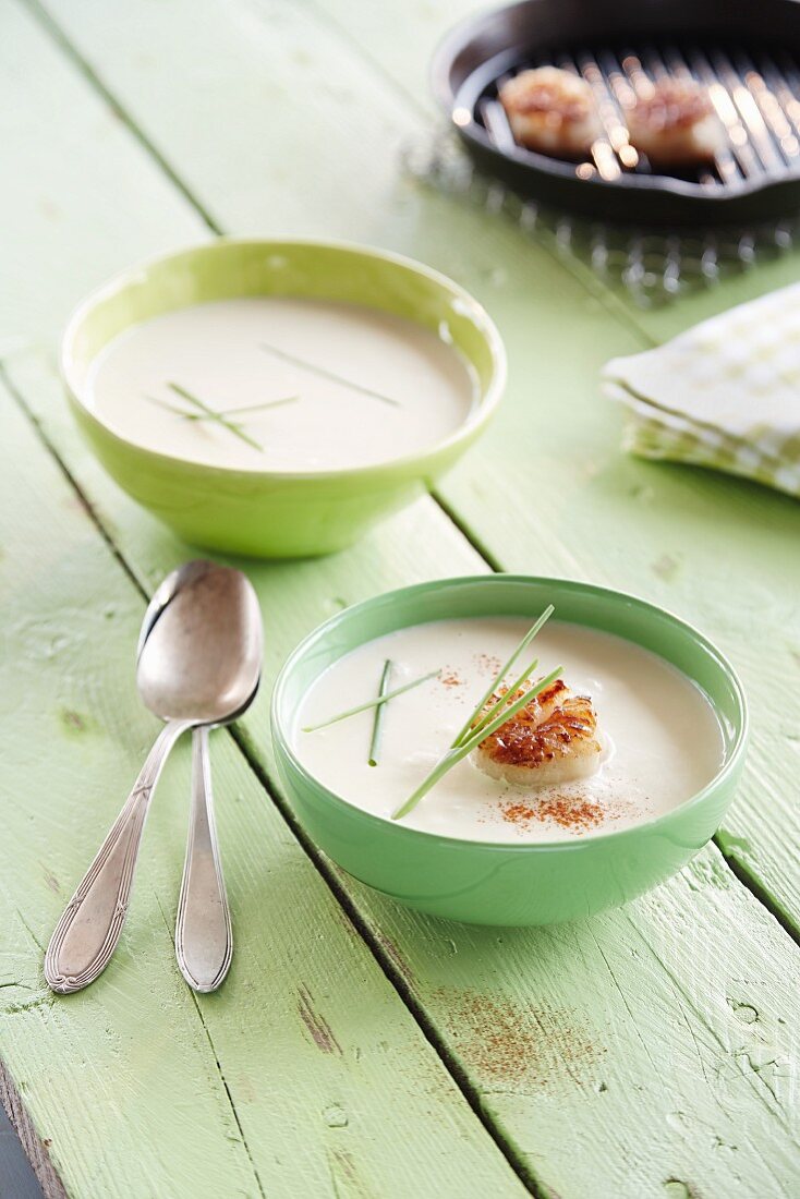 Cream of asparagus soup with scallops