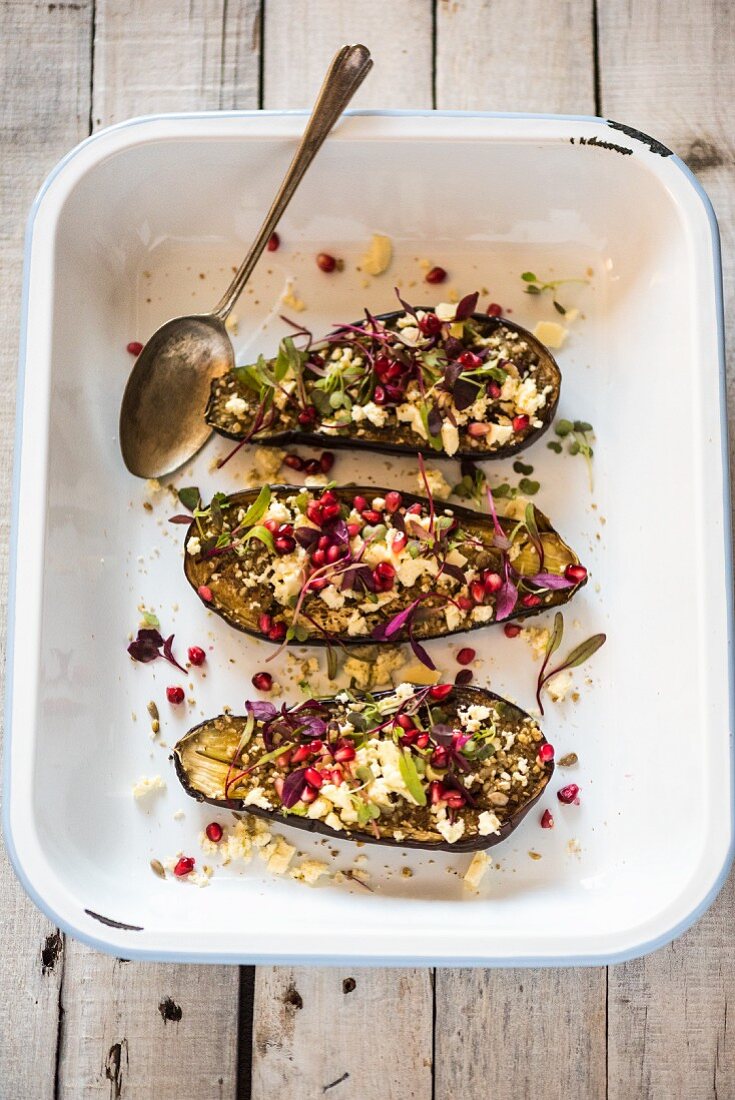 Roasted aubergines with feta cheese and pomegranate seeds