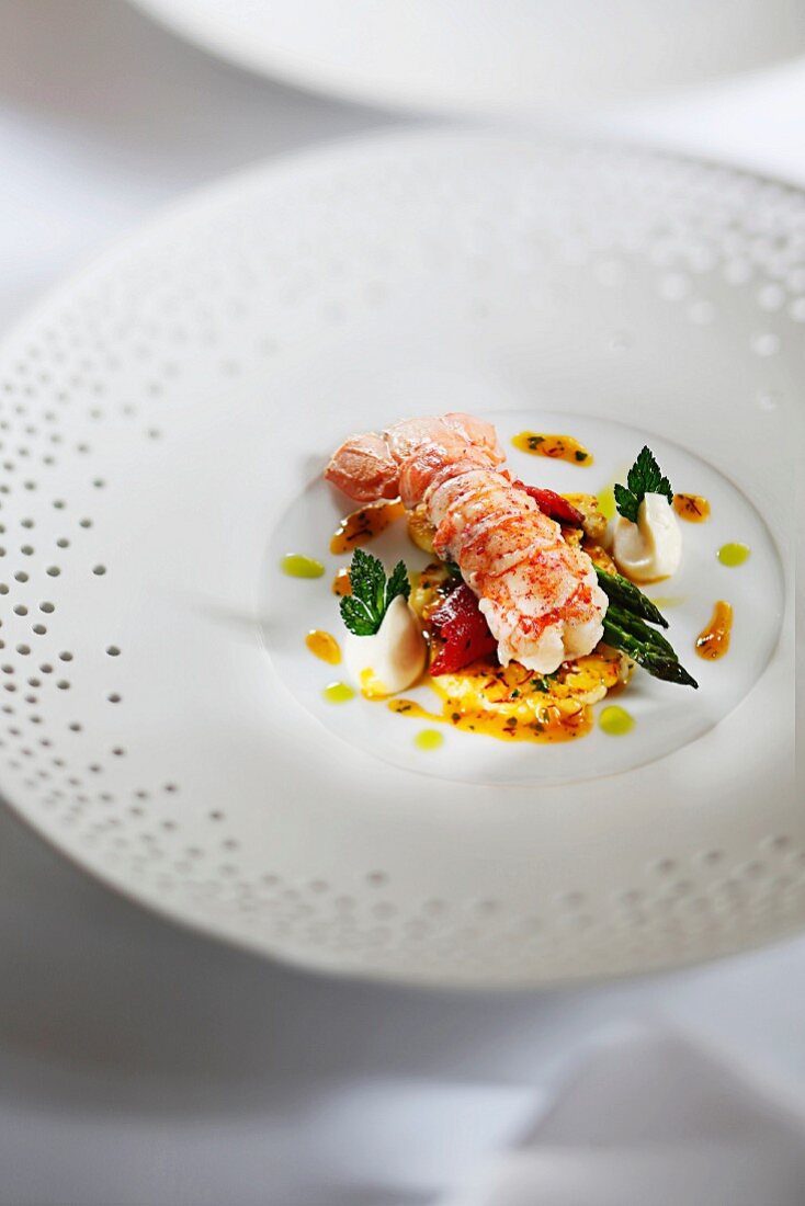 Sautéed langoustine on a bed of cauliflower in an orange and saffron reduction and parsley oil