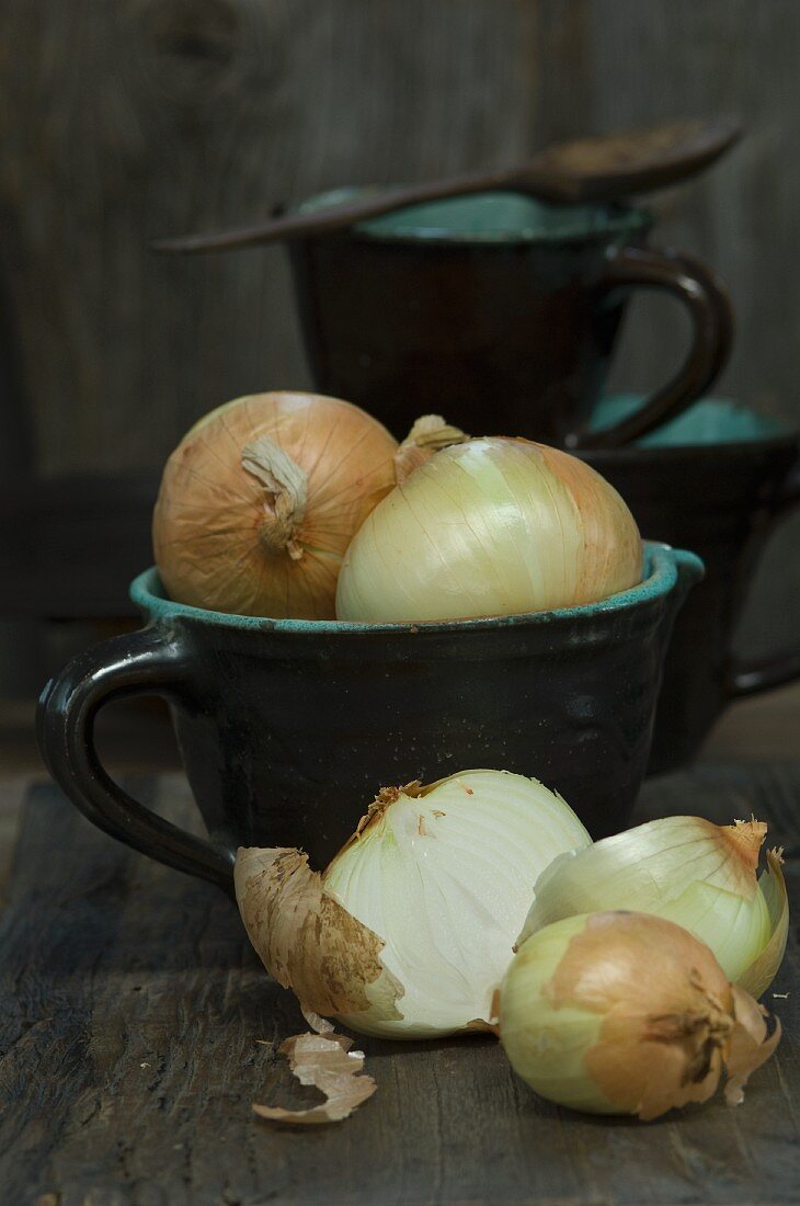 Large sweet onions in a jug, whole and sliced