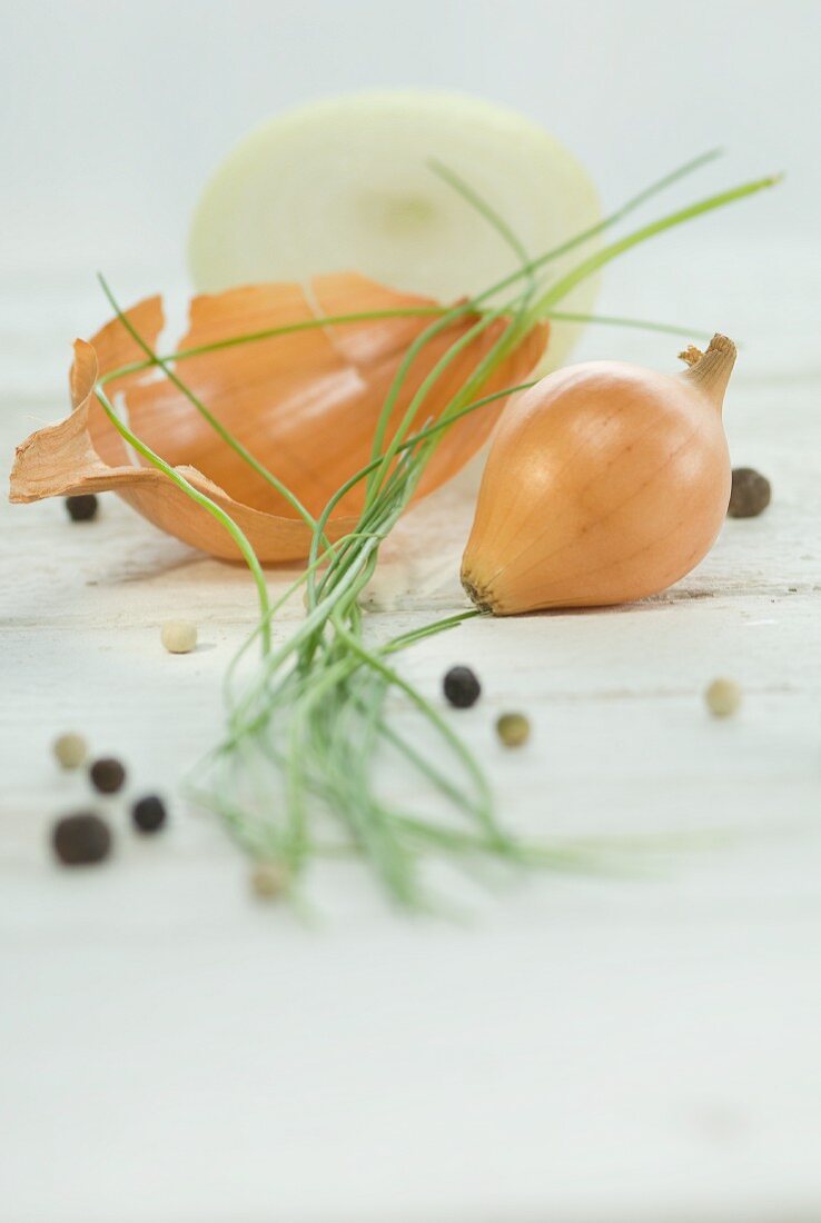 A sliced onion, chives and peppercorns