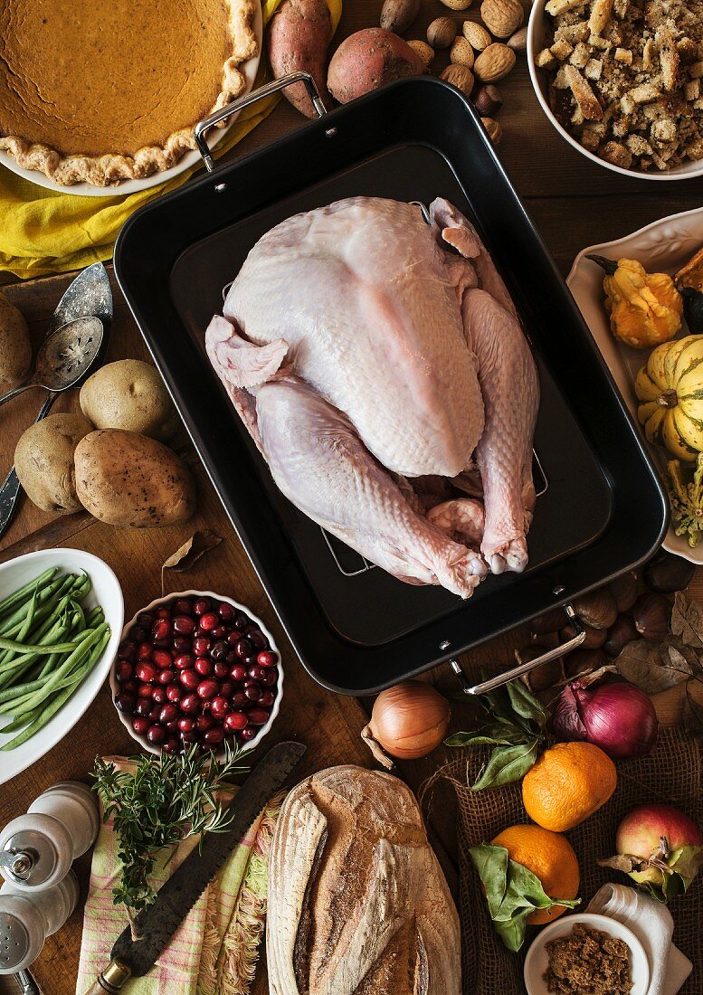 A ready-to-roast Thanksgiving turkey with side dishes