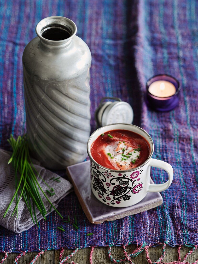Borscht (beetroot soup, Eastern Europe) in an enamel mug