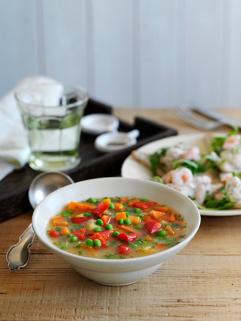 Vegetable soup with peppers, carrots and peas