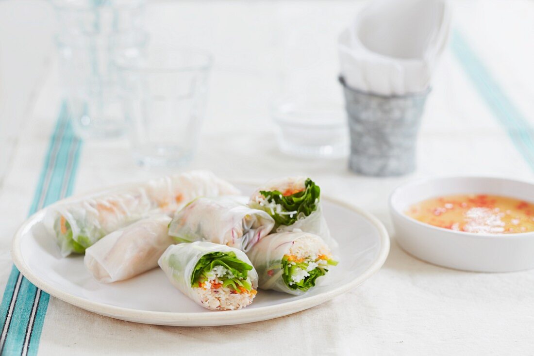 Rice paper rolls filled with carrots, rice noodles, shrimps and chilli dip (Vietnam)