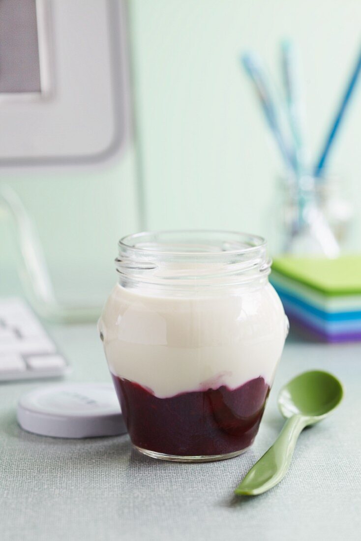 Yoghurt with berry compote in a jar