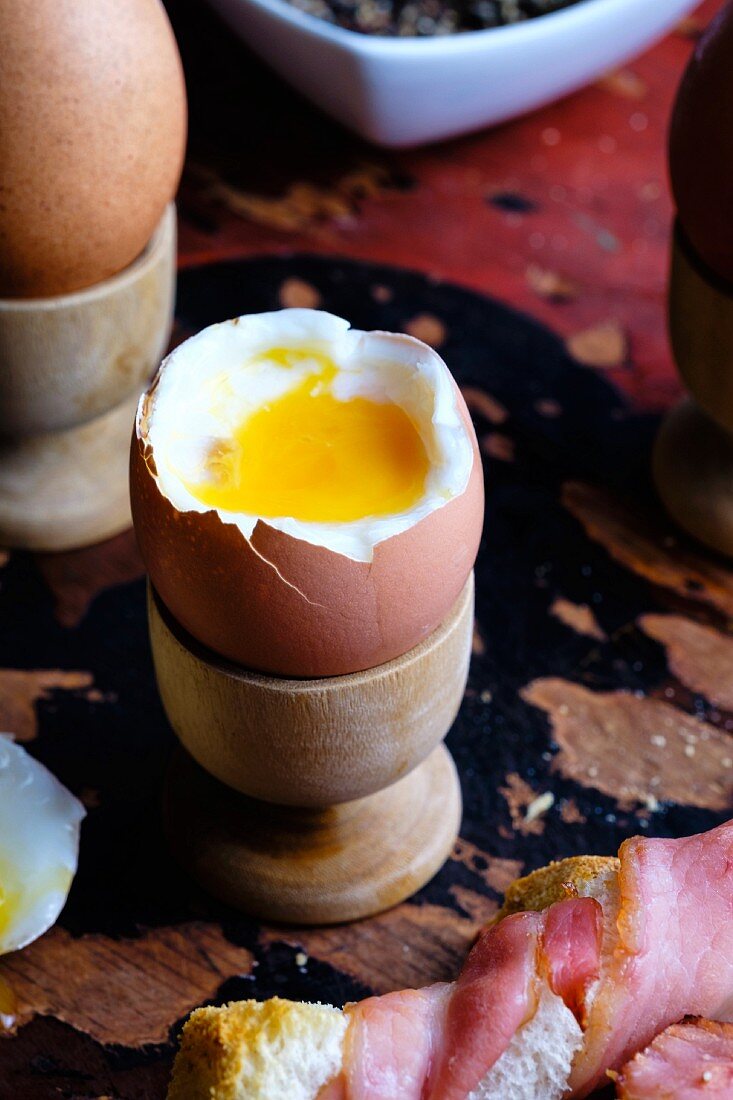 Soft boiled eggs with bacon-wrapped toast