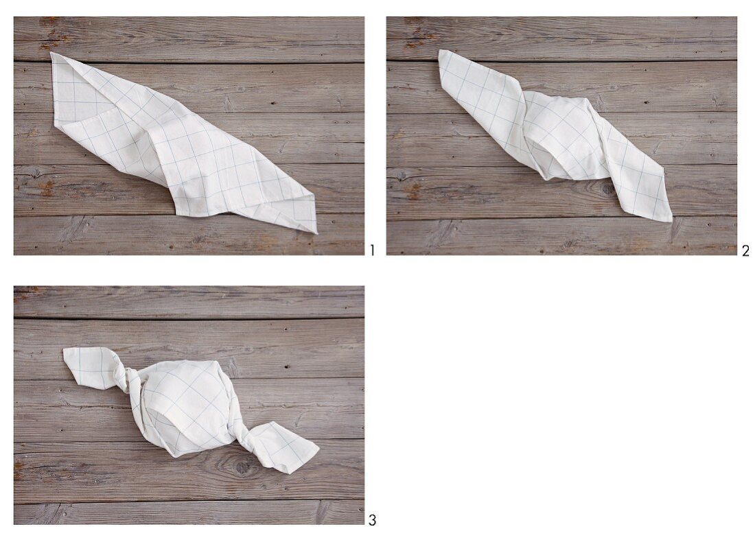 A white napkin being folded into a sweet shape