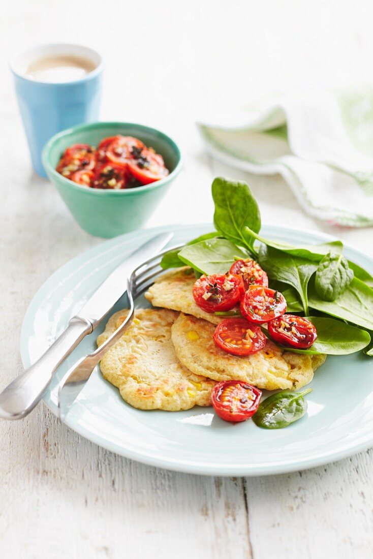 Sweetcorn pancakes with roasted cherry tomatoes, spinach and a mug of tea