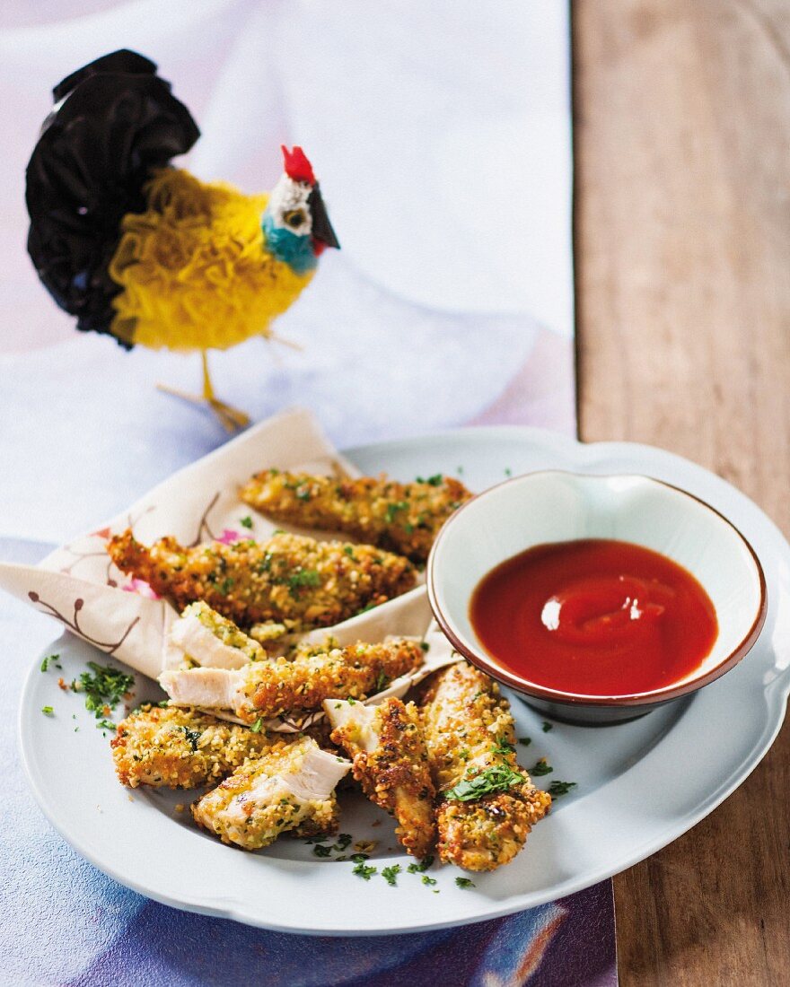 Chicken goujons with an almond coating and a tomato dip