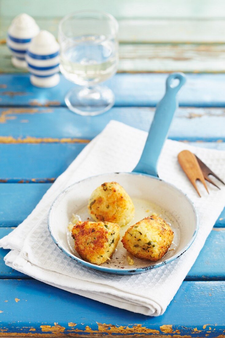 Crab croquettes in a small pan