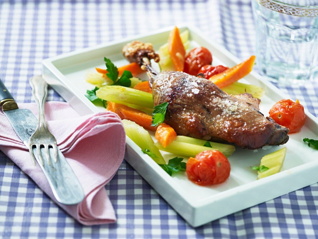 Chicken leg with celery, carrots and tomatoes