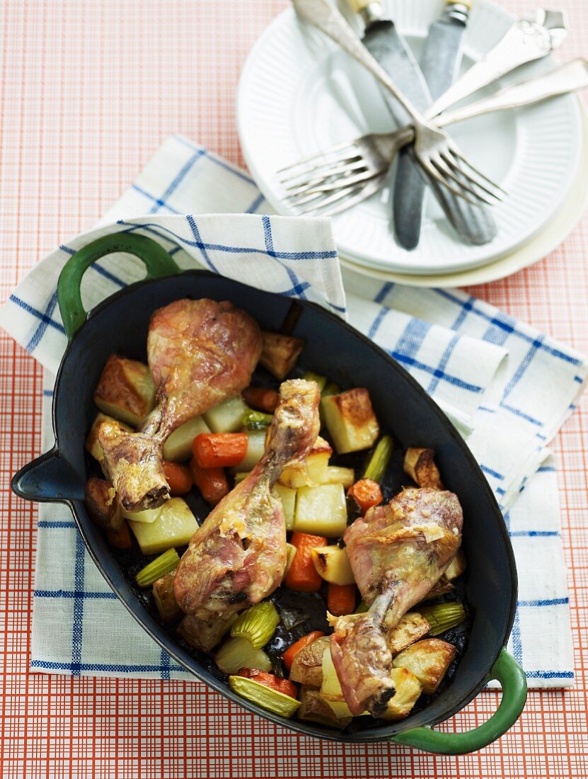 Chicken legs on a bed of vegetables