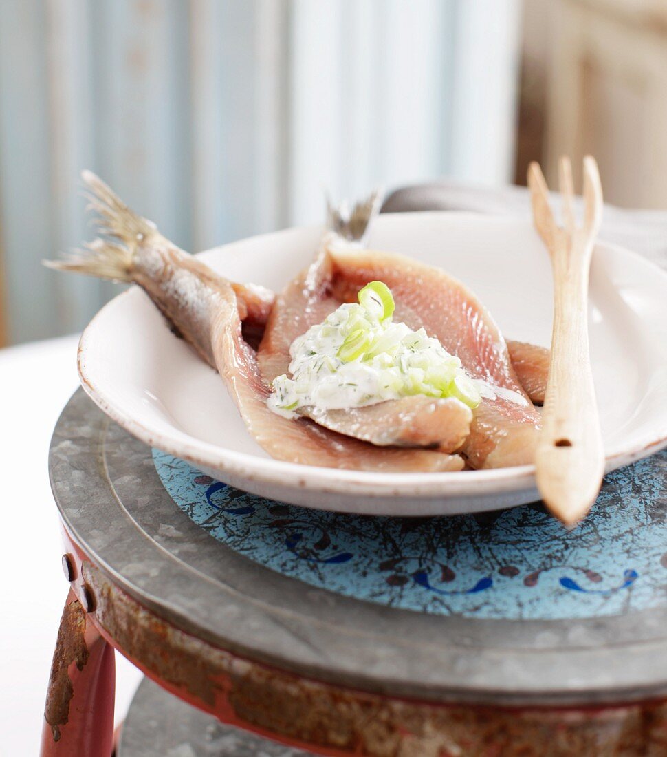 Soused herring fillets with creamy cucumber and spring onions