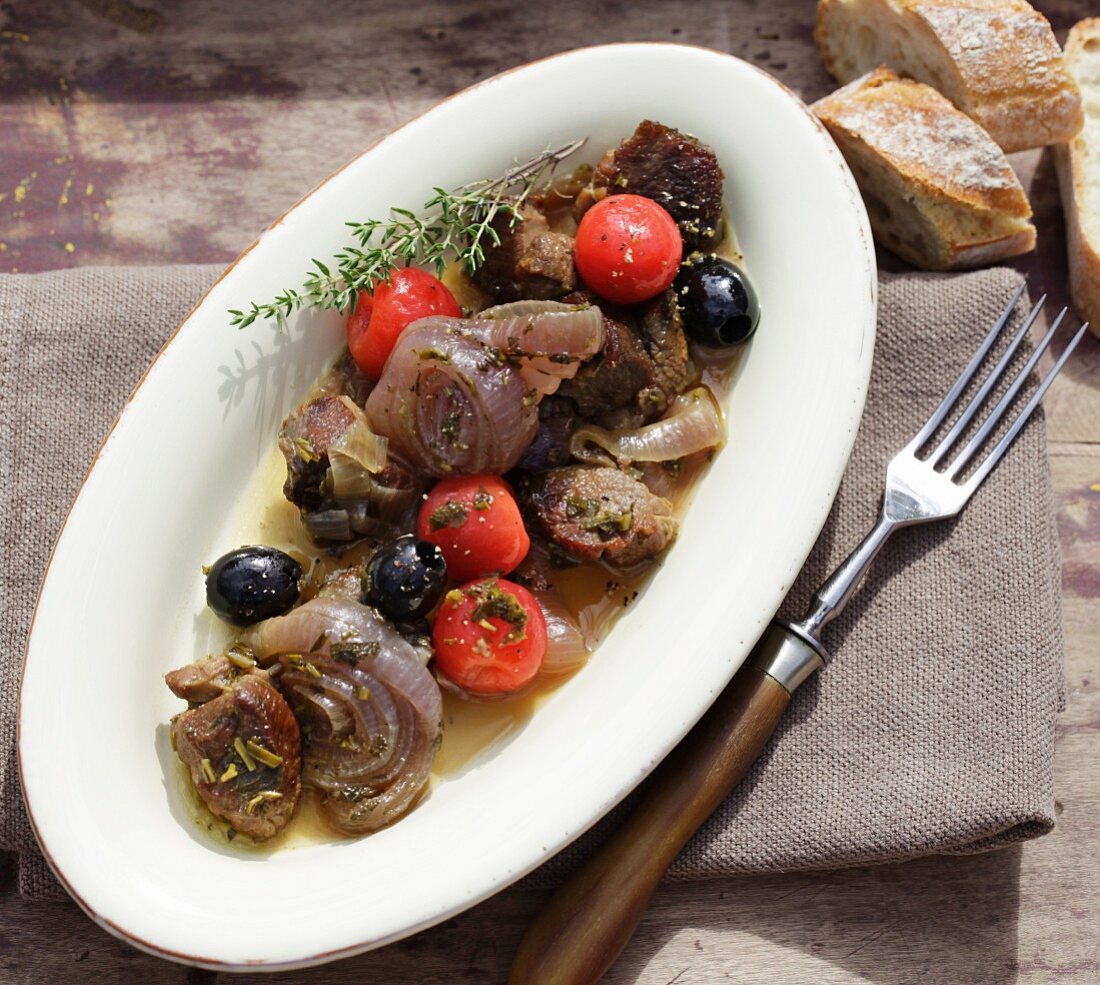 Braised lamb stew with onions, olives and cherry tomatoes