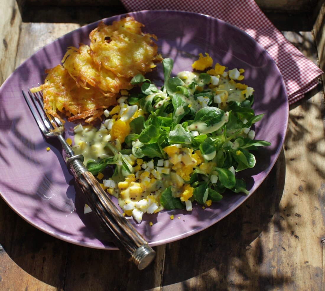 Mini potato fritters with an egg and lamb's lettuce salad