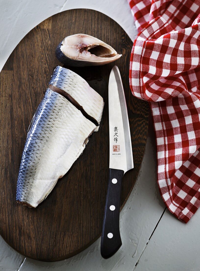Fresh herring on a wooden chopping board