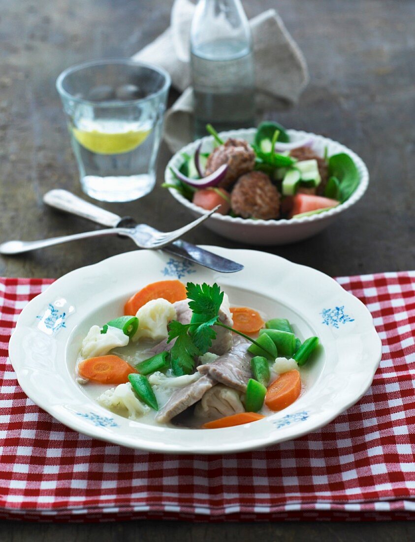 Veal fricassee with vegetables and salad with meatballs