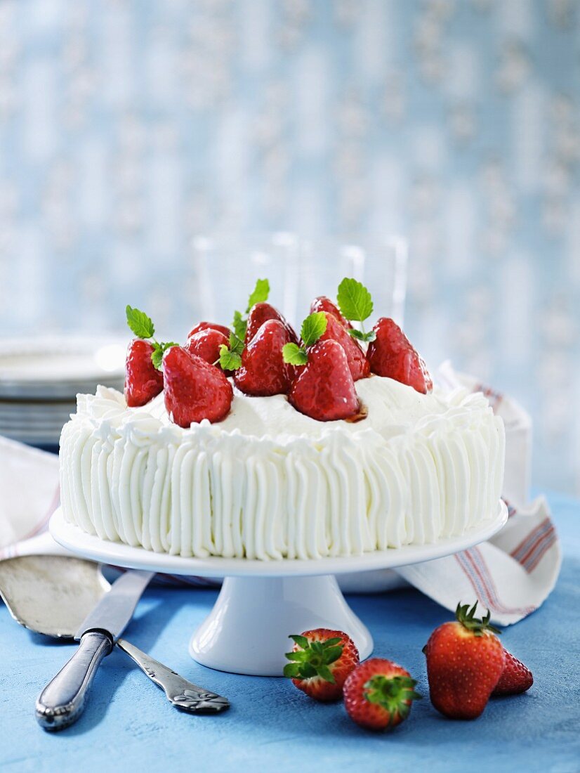 A cream cake with glazed strawberries
