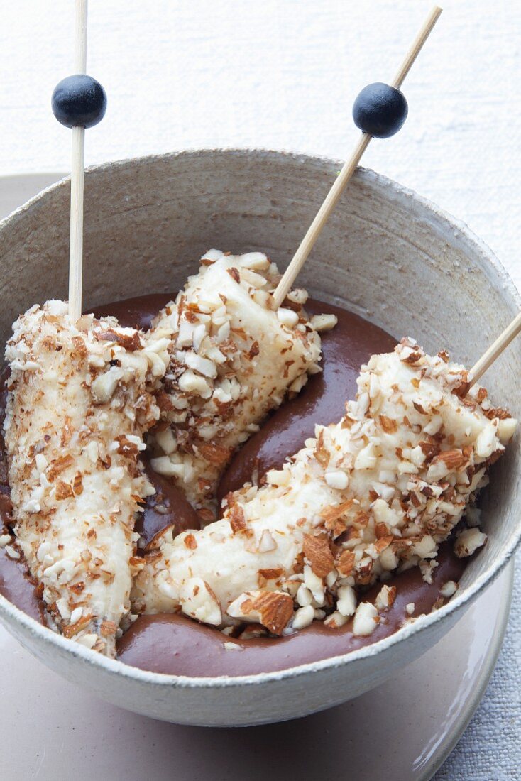 Bananas with an almond coating and chocolate sauce