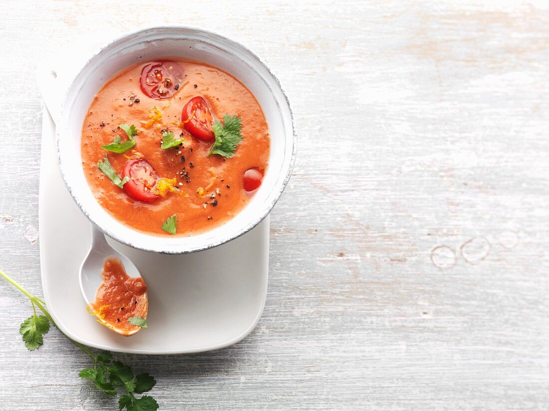 Cream of tomato soup with coriander, spring onions and chilli