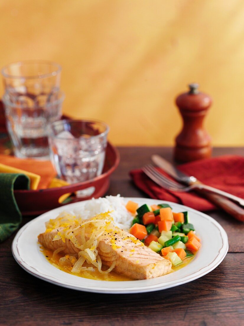 Salmon in an orange sauce with vegetables and rice