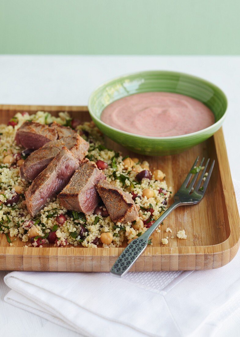 Lamb with pomegranate and chickpea couscous and a dip