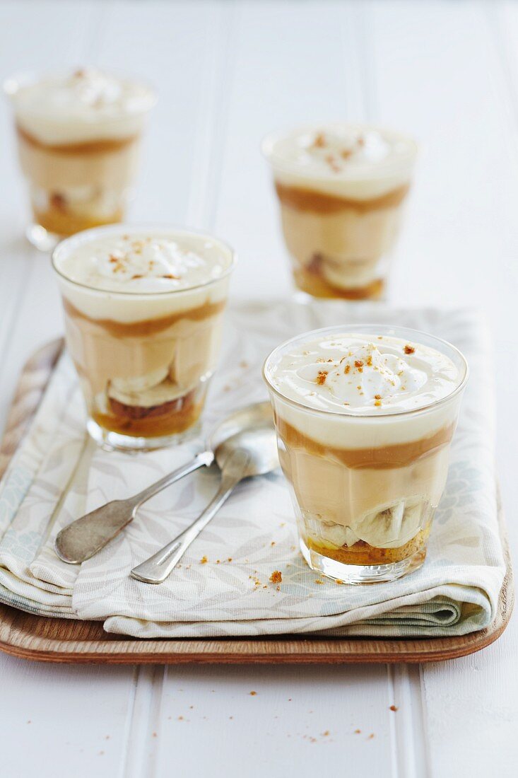 Layered deserts with caramel cream, bananas and creamy yoghurt