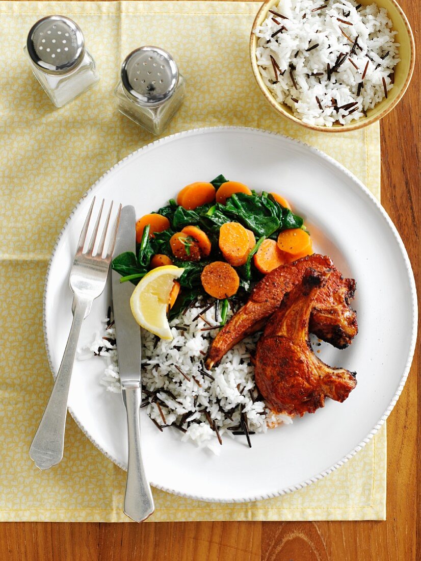 Lamb chops with harissa served with rice and fried vegetables