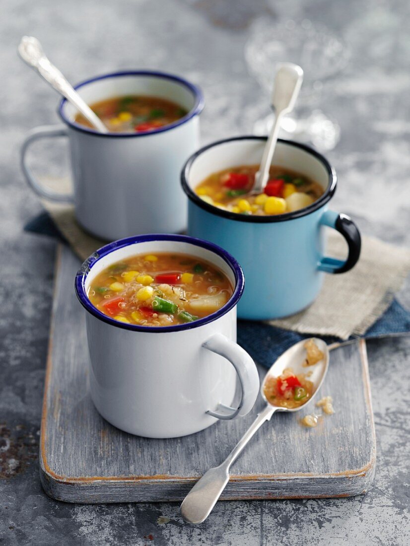 Thick quinoa and sweetcorn soup in enamel cups