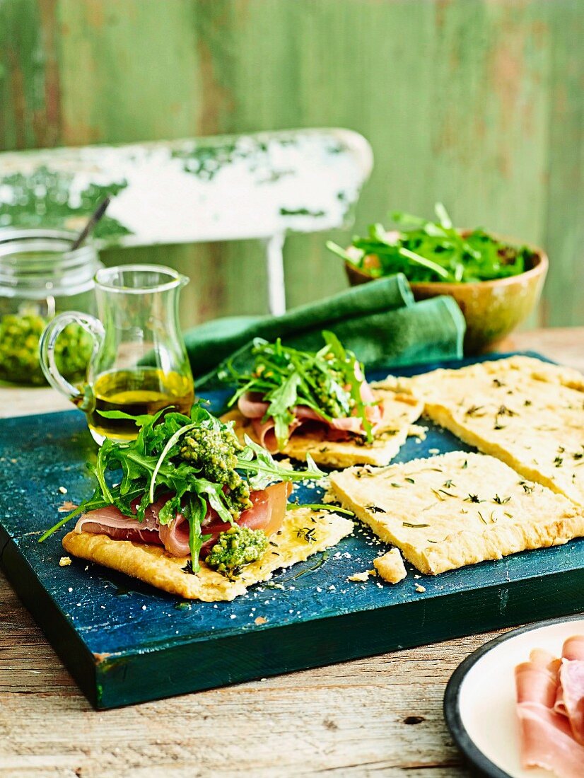 Olive oil tarts with proscuitto and pesto