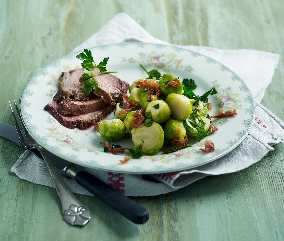 Roast lamb with Brussels sprouts and crispy ham