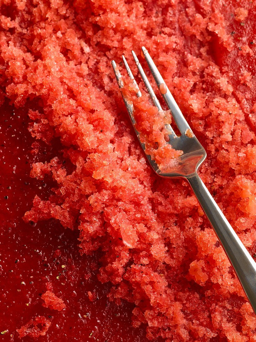 Raspberry granita with a fork (close-up)