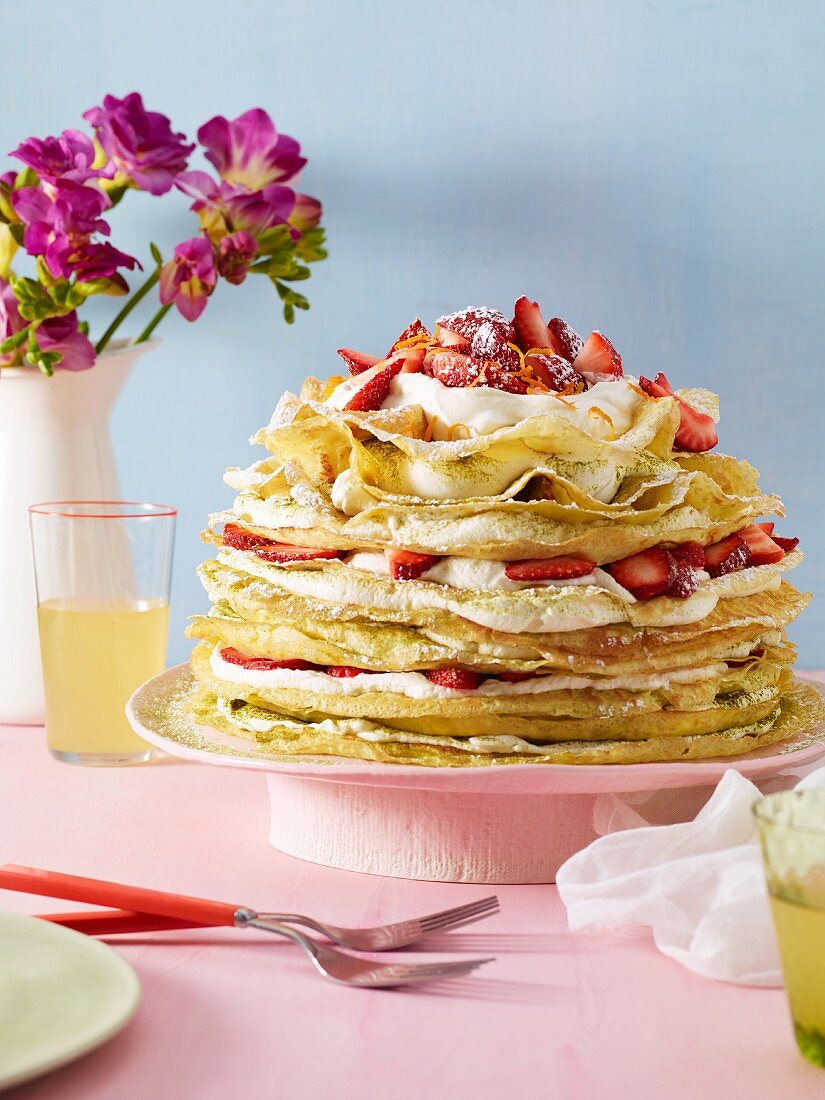 A pancake cake with strawberries and crème fraîche