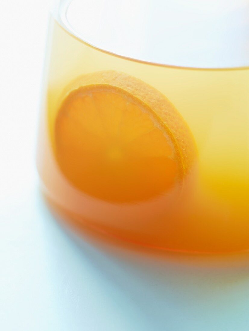 Orange juice in a glass jug (close-up)