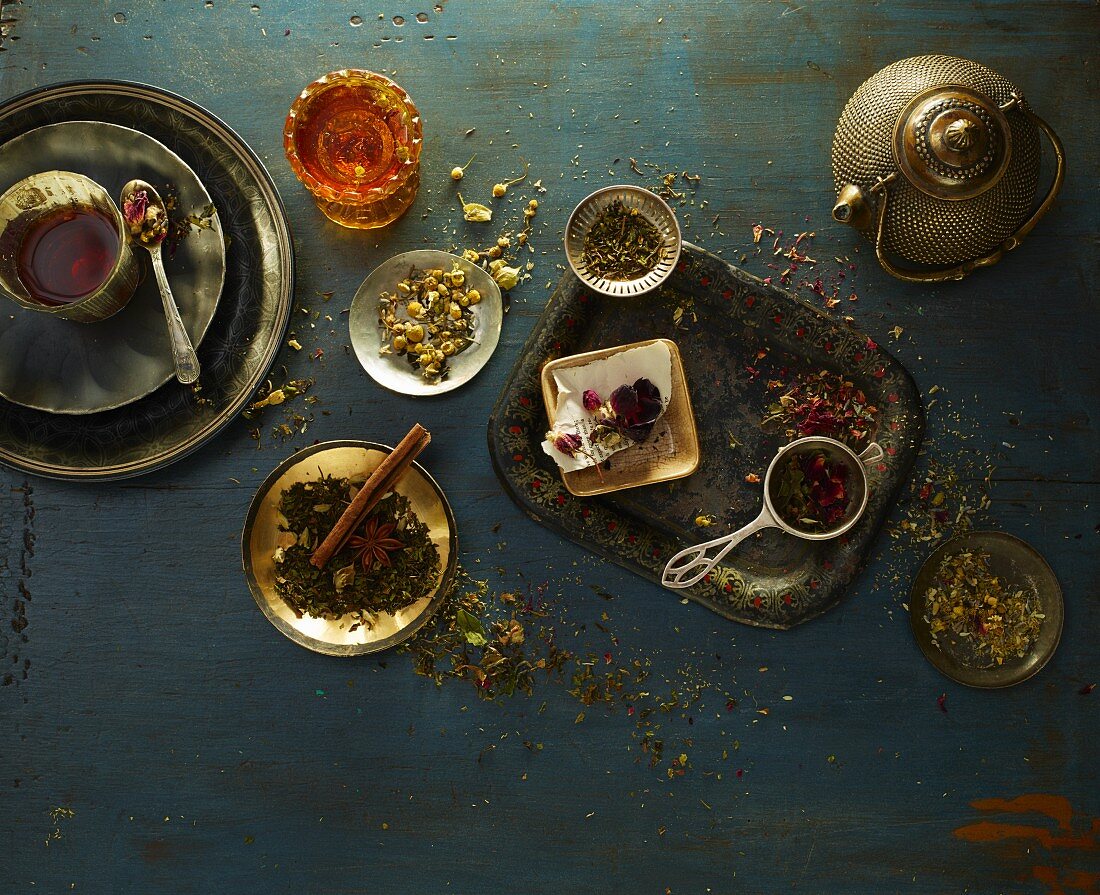 An arrangement of tea utensils and ingredients on a wooden table