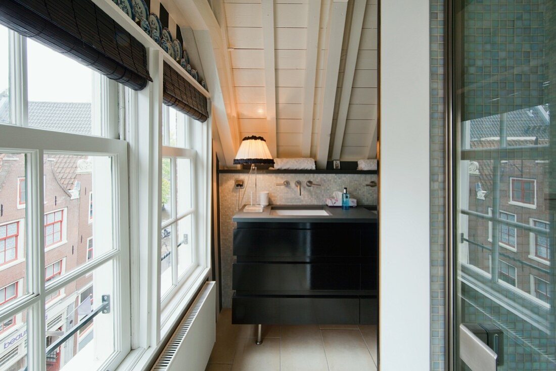 Gable-end window in attic bathroom; washstand on knee wall in background