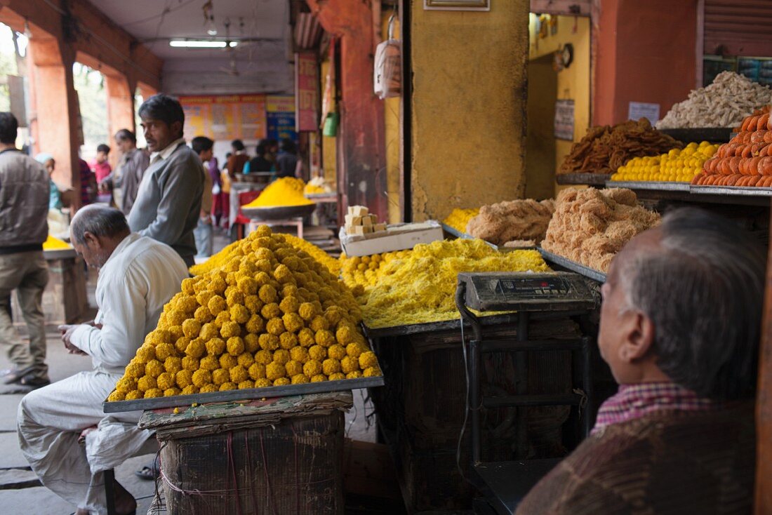 A street vendor selling a variety of sweets in Jaipur, India