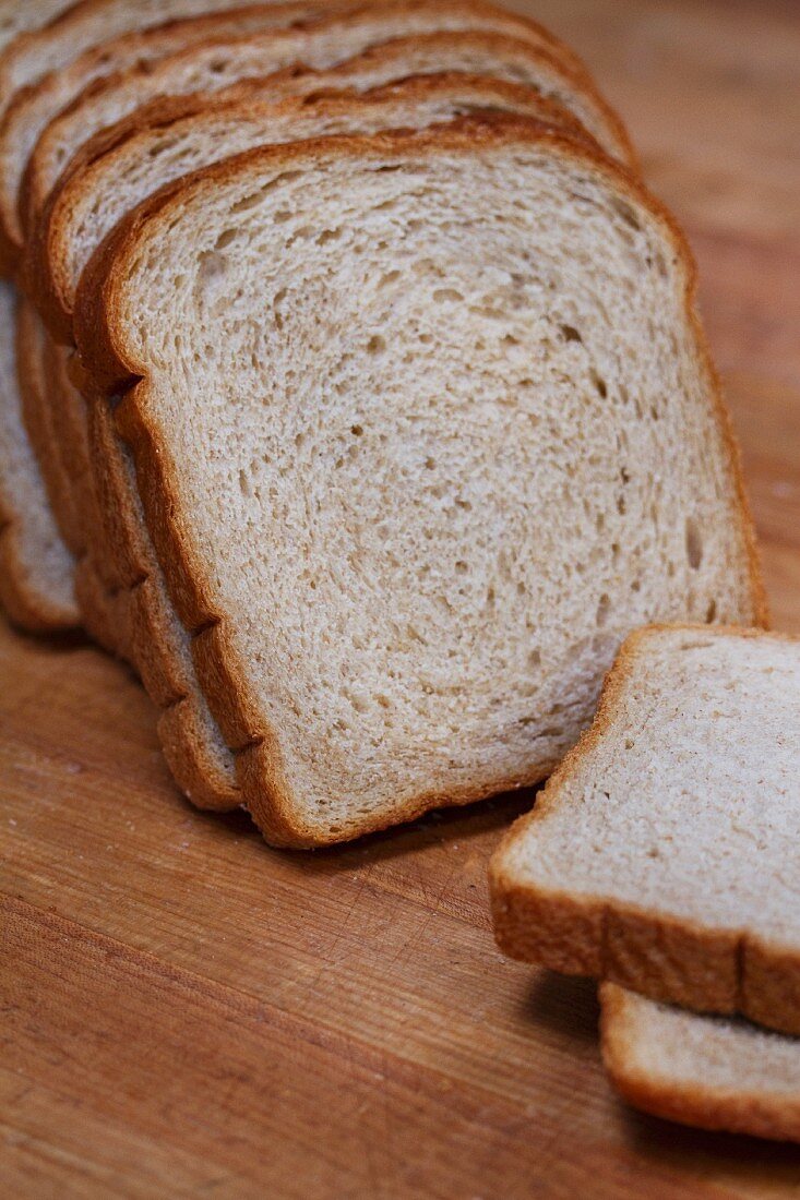 Slices of white bread on a wooden table